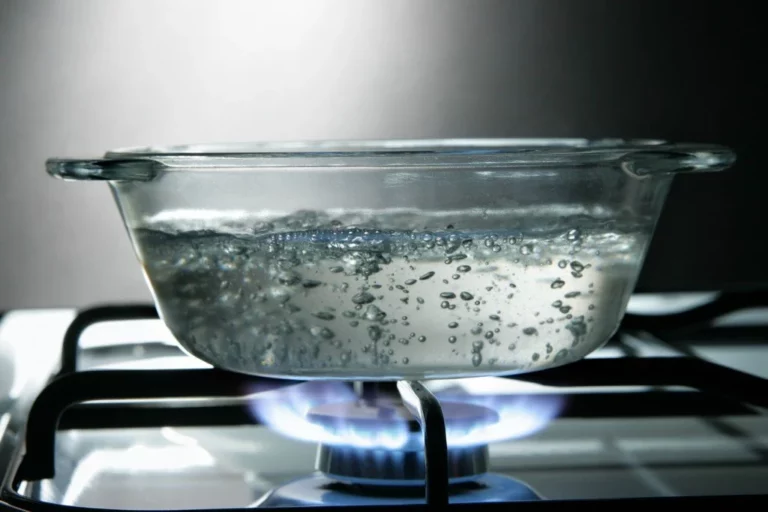 Boiling water in pot to show how to melt frozen gutters in colorado